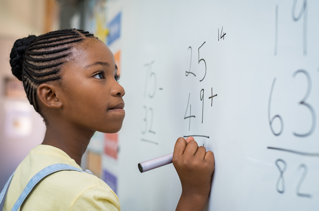 Young girl doing math on whiteboard2